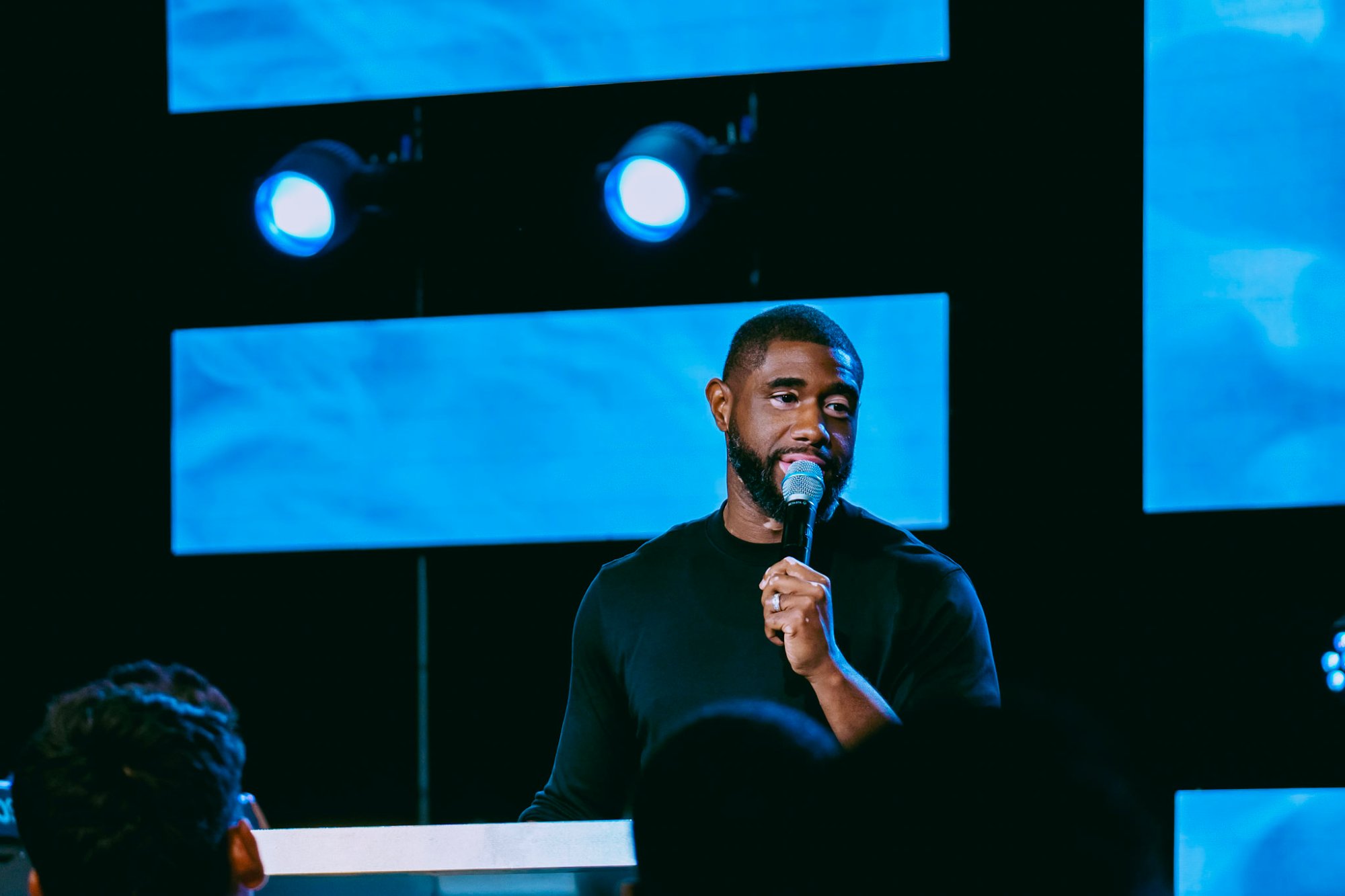 Isaac Valme speaking on stage